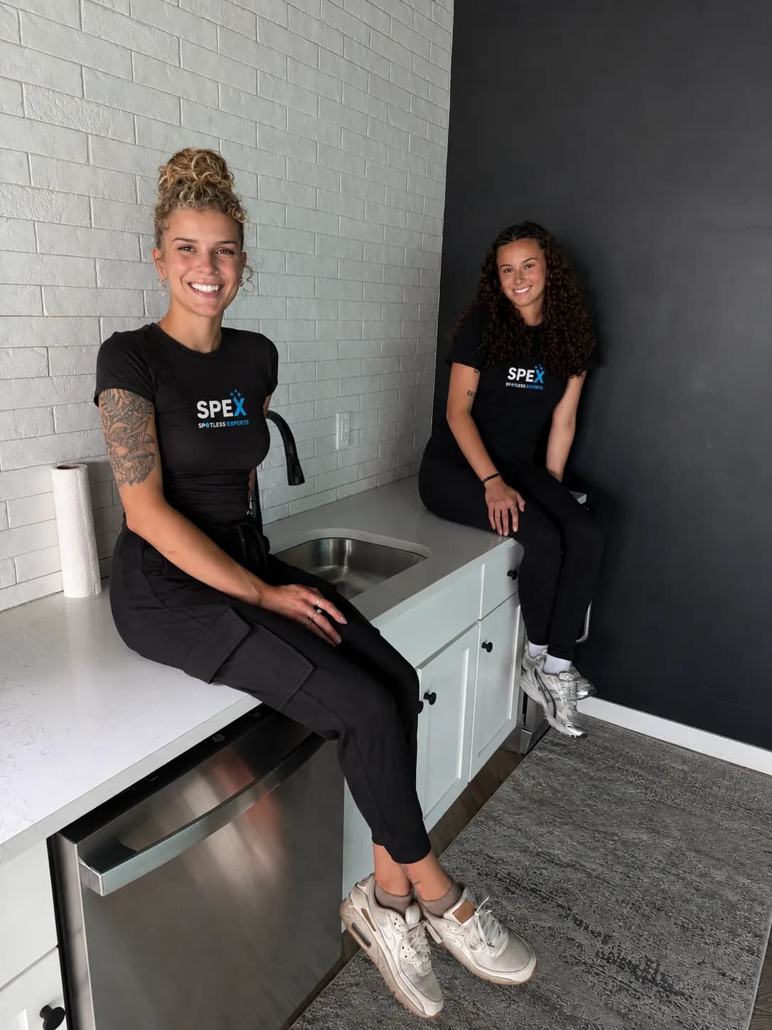 Corinne and Tayah MacRae, the sisters who founded SPEX, wearing SPEX Spotless Experts shirts